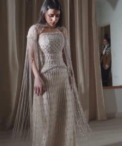 فستان سهرة أوف وايت مطرز كريستال بتصميم فاخر مع شراشيب